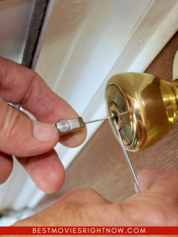 Closeup of locksmith picking a gold lock