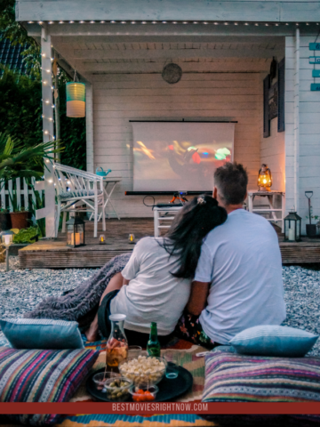 couple looking movie outdoor at night