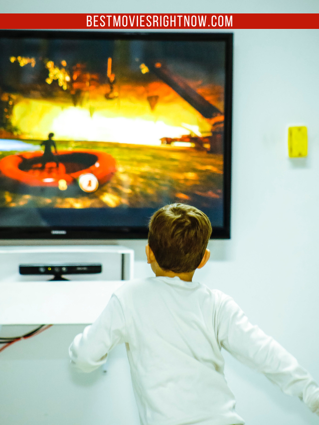 Boy Standing In Front Of Flat Screen Tv
